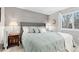 Comfortable bedroom with a large bed, side tables with lamps, and a bright window at 5426 Bobcat St, Frederick, CO 80504