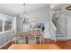 Elegant dining room featuring a chandelier, hardwood floors and staircase leading to the upper level at 5426 Bobcat St, Frederick, CO 80504
