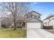 Charming gray two-story home with a well-maintained lawn and a two-car garage in a residential neighborhood at 5426 Bobcat St, Frederick, CO 80504