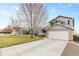 Charming gray two-story home with a well-maintained lawn and long driveway in a residential neighborhood at 5426 Bobcat St, Frederick, CO 80504