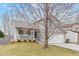 Charming gray two-story home with a front porch and well-maintained lawn in a residential neighborhood at 5426 Bobcat St, Frederick, CO 80504