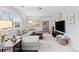 Cozy living room with a large sectional sofa, bright window and stylish decor at 5426 Bobcat St, Frederick, CO 80504