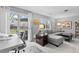 Bright living room featuring a door to backyard, large sectional sofa and modern decor at 5426 Bobcat St, Frederick, CO 80504