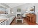 Bright living room featuring a fireplace, neutral furniture, and hardwood floors for a comfortable ambiance at 5426 Bobcat St, Frederick, CO 80504