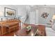 Spacious living room with hardwood floors, a piano, and staircase, offering a view of the home's layout at 5426 Bobcat St, Frederick, CO 80504