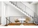 Modern staircase with metal railing and small table at 1218 Perry St, Denver, CO 80204