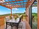 Outdoor back deck with beautiful mountain views, patio furniture, and overhead pergola at 953 Gilia Dr, Golden, CO 80401
