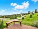 Enjoy panoramic views from the deck with custom wood bench seating, overlooking the lush surroundings at 953 Gilia Dr, Golden, CO 80401