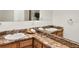 Well-lit bathroom featuring double sinks and marble countertops with modern fixtures at 953 Gilia Dr, Golden, CO 80401