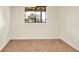 Bright bedroom features neutral carpet, white walls, and a window offering outdoor views at 953 Gilia Dr, Golden, CO 80401