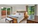 Cozy bedroom with a wood bed frame, bedside tables, and access to an outdoor patio at 953 Gilia Dr, Golden, CO 80401