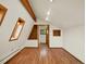 Bedroom with hardwood floors, beam, and custom shelving at 953 Gilia Dr, Golden, CO 80401
