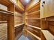 Spacious walk-in closet with wooden built-in shelves and ample storage space at 953 Gilia Dr, Golden, CO 80401