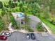 Aerial view of community clubhouse & pool, surrounded by mature trees and lush landscaping at 953 Gilia Dr, Golden, CO 80401