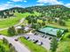 Aerial view showcases community pool, tennis courts, playground, and ample parking spaces at 953 Gilia Dr, Golden, CO 80401