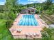 Top-down aerial view of a large community pool with plenty of lounge chairs for sunbathing at 953 Gilia Dr, Golden, CO 80401