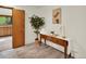 Bright hallway with wood-look flooring, wood trim, and a tranquil view of outdoor scenery at 953 Gilia Dr, Golden, CO 80401