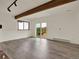 Bright living room with wood-look floors and sliding doors to a deck with scenic views at 953 Gilia Dr, Golden, CO 80401