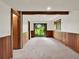 Spacious room with wood trim, carpet and a sliding glass door leading to outdoor views at 953 Gilia Dr, Golden, CO 80401