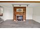 Inviting living room features a brick fireplace, wood accent wall, and neutral paint at 953 Gilia Dr, Golden, CO 80401
