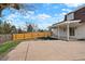 Backyard with patio, new fence, and a lush lawn, perfect for outdoor activities at 6325 W Portland Pl, Littleton, CO 80128