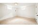 Finished basement with cozy carpet and two windows offering natural light to the room at 6325 W Portland Pl, Littleton, CO 80128