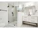 Modern bathroom with a glass shower, stylish vanity, and updated fixtures at 6325 W Portland Pl, Littleton, CO 80128