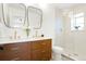 Modern bathroom with double vanity sinks, gold fixtures, and a glass-enclosed shower at 6325 W Portland Pl, Littleton, CO 80128