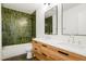 Stylish bathroom with a double vanity, modern fixtures, and a shower over the bathtub at 6325 W Portland Pl, Littleton, CO 80128