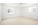 Well-lit bedroom features neutral walls and carpet with two windows at 6325 W Portland Pl, Littleton, CO 80128