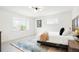 Bright bedroom with two windows that let in plenty of natural light and a plush rug at 6325 W Portland Pl, Littleton, CO 80128