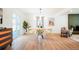Light-filled dining room features modern furnishings, hardwood floors, and access to a patio at 6325 W Portland Pl, Littleton, CO 80128