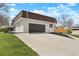 Charming two-story home with attached garage, long driveway, and well-maintained lawn at 6325 W Portland Pl, Littleton, CO 80128