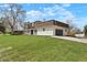 Exterior of the home showcasing a brown roof, landscaped grounds, and an attached garage at 6325 W Portland Pl, Littleton, CO 80128