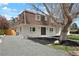 Charming two-story home with a brown roof, gray gravel drive, and manicured front yard at 6325 W Portland Pl, Littleton, CO 80128
