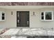 Close-up of front door with a modern design, featuring a dark finish and house number at 6325 W Portland Pl, Littleton, CO 80128