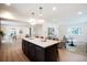 Open-concept kitchen with a center island flows seamlessly into the dining and living areas at 6325 W Portland Pl, Littleton, CO 80128