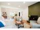 Inviting living room with a cozy fireplace, neutral decor, and an open view to the dining area at 6325 W Portland Pl, Littleton, CO 80128