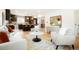 Open-concept living room with modern decor, including a stylish kitchen island and comfortable seating at 6325 W Portland Pl, Littleton, CO 80128