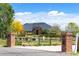 Inviting brick entrance with a well-manicured lawn and mature trees leading to a stately home at 2366 Shore Side Dr, Berthoud, CO 80513
