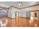 Open-concept living room featuring hardwood floors, arched doorways, and recessed lighting at 2366 Shore Side Dr, Berthoud, CO 80513