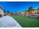 Expansive backyard with lush artificial turf, landscaping, and a stone retaining wall at 4213 Hickory Oaks St, Castle Rock, CO 80104
