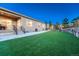 Backyard with artificial turf, landscaping, and a covered patio, ideal for low-maintenance enjoyment at 4213 Hickory Oaks St, Castle Rock, CO 80104
