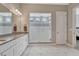Modern bathroom with a double vanity, large walk-in shower, marble floors and grey and white tiling at 4213 Hickory Oaks St, Castle Rock, CO 80104