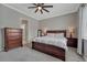 Comfortable bedroom with a king-size bed, matching nightstands, dresser, and an ensuite bathroom at 4213 Hickory Oaks St, Castle Rock, CO 80104
