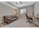 Carpeted bedroom with a leather sofa, a desk, and a window, offering a versatile space for relaxation and work at 4213 Hickory Oaks St, Castle Rock, CO 80104