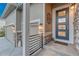 Welcoming front entrance featuring stone accents, modern door, and stylish exterior lighting at 4213 Hickory Oaks St, Castle Rock, CO 80104