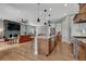 Open kitchen with a center island, modern appliances, and seamless flow to the living area at 4213 Hickory Oaks St, Castle Rock, CO 80104