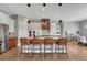 Elegant kitchen featuring a large island with bar seating, modern lighting, and stainless steel appliances at 4213 Hickory Oaks St, Castle Rock, CO 80104