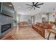 Spacious living room with a fireplace, hardwood floors, and comfortable leather furniture at 4213 Hickory Oaks St, Castle Rock, CO 80104